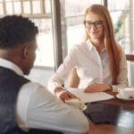 Man and woman sat in a coffee shop having a job interview