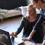 Two women looking at laptop