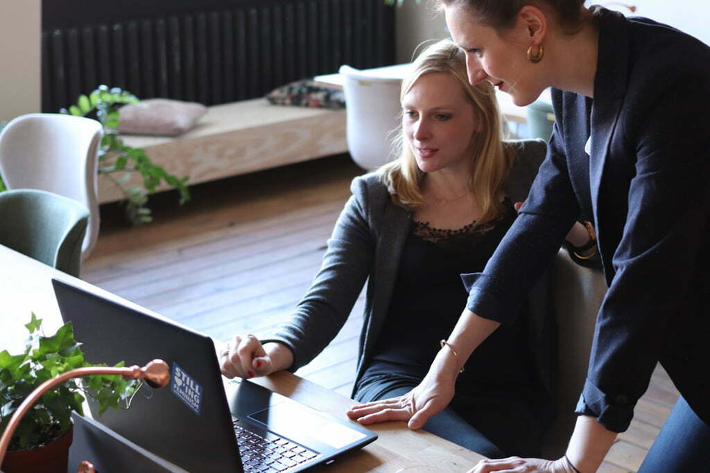 Two women looking at laptop