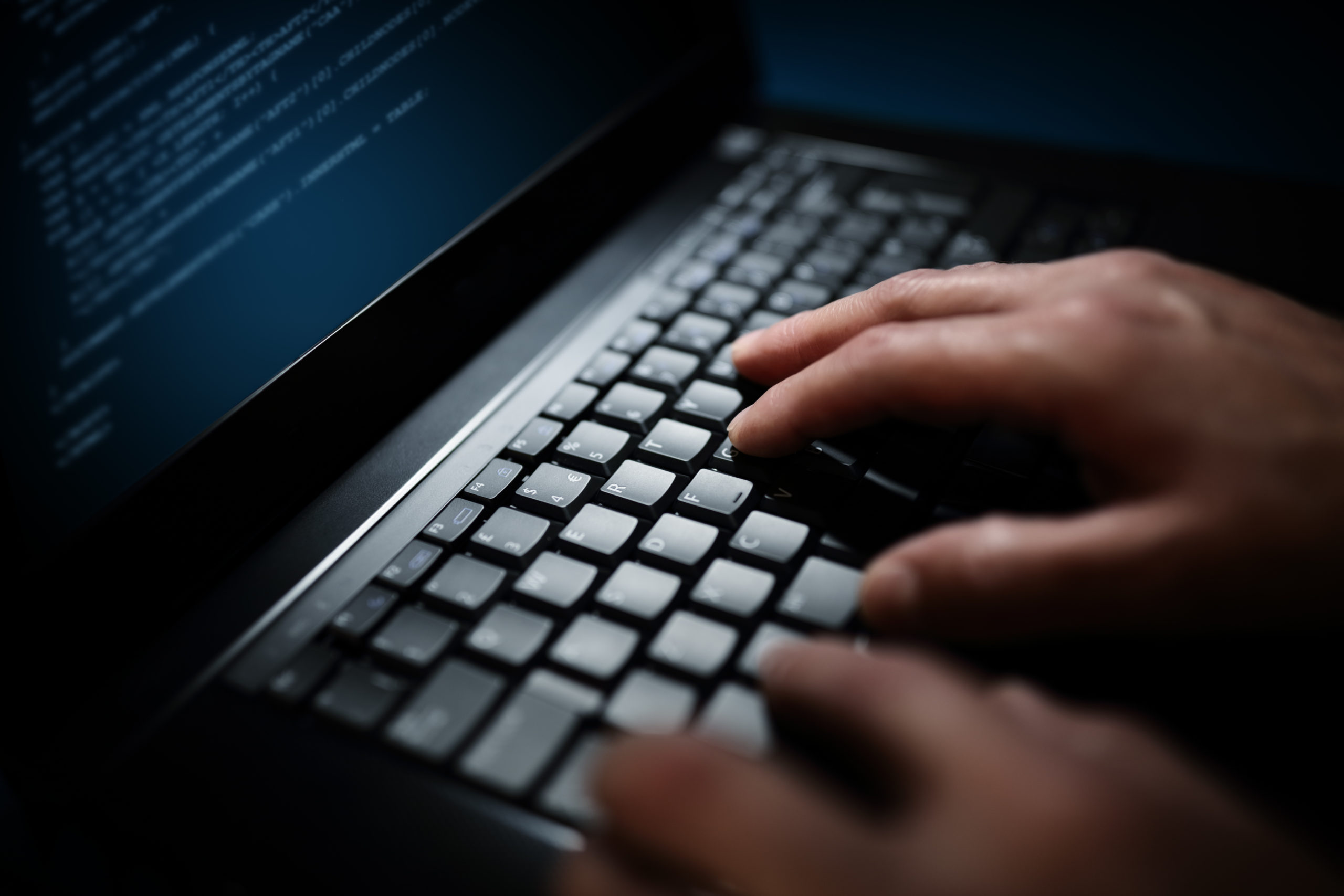 Programmer or computer hacker typing on laptop keyboard IT recruitment agency in Shrewsbury, Shropshire
